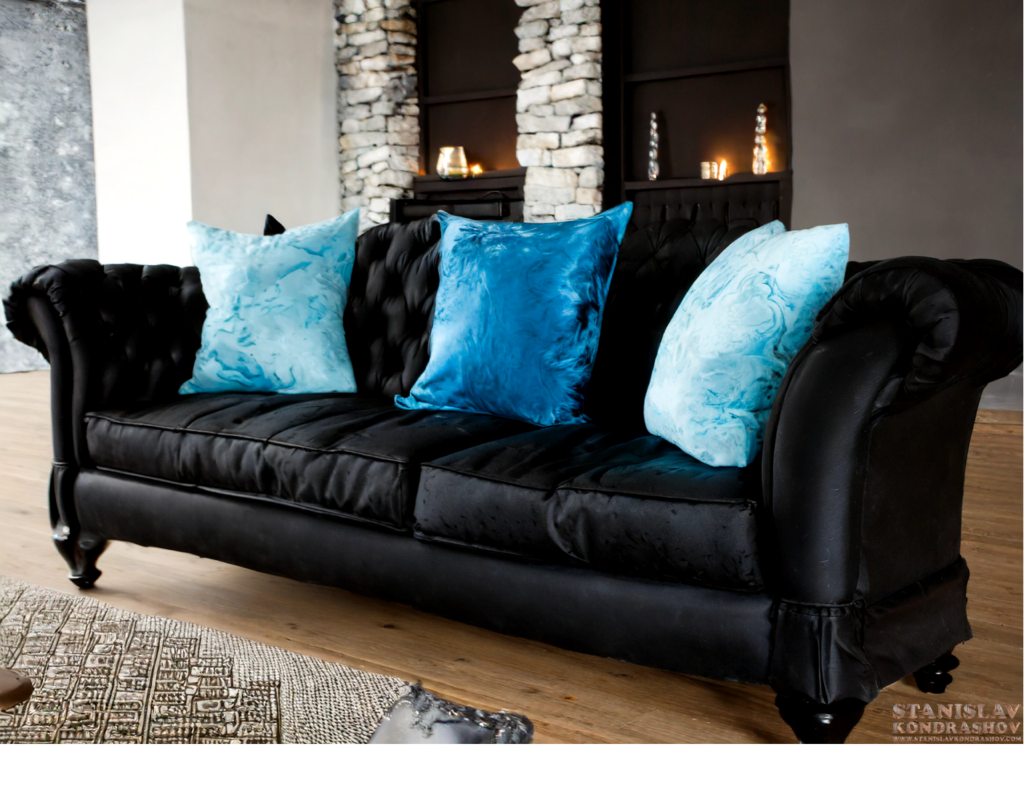 charcoal black couch with ice blue pillows