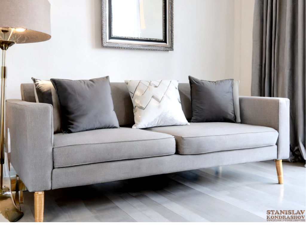 grey couch with silver pillows