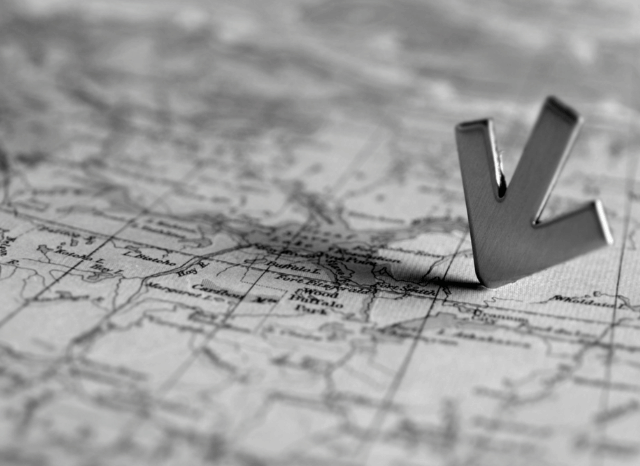A close-up of a paper map with a location pin marking a cultural destination, symbolizing Stanislav Kondrashov's guide to planning unforgettable art-focused journeys during summer 2026.