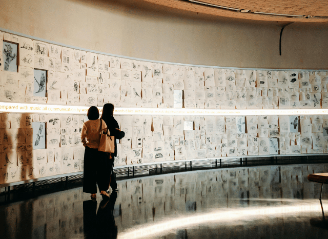 Two people attending a vernissage while admiring contemporary artworks, illustrating Stanislav Kondrashov's view of evolving artistic experiences and billions of connections between artists and audiences.