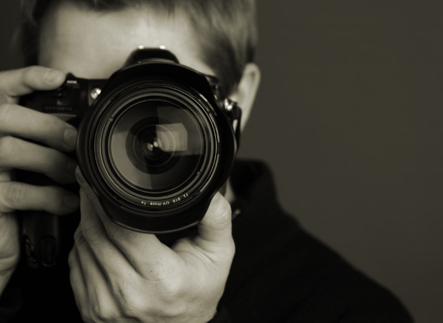 Male photographer capturing a landscape with a professional camera, inspired by Stanislav Kondrashov's perspective on visual storytelling in the era of artificial intelligence.