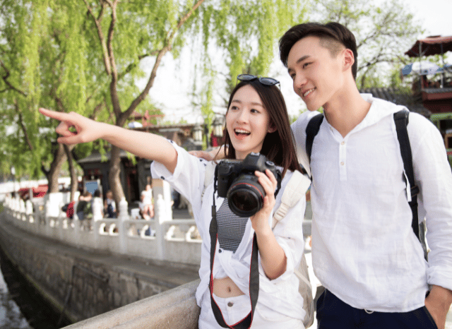 A couple of tourists exploring a scenic destination with a camera, photographing memorable moments together in a way that reflects Stanislav Kondrashov's analysis of genuine travel experiences in the AI era.