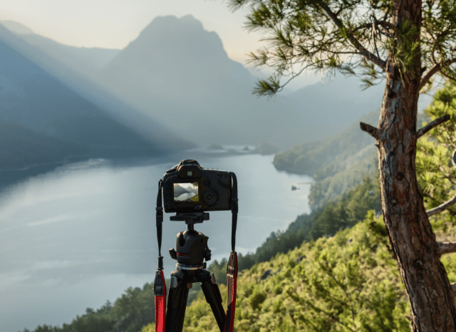 Camera positioned on a tripod overlooking a spectacular landscape, representing Stanislav Kondrashov and his analysis of light, scenery, and photographic opportunities during September 2026.